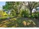Large backyard featuring mature trees and lush greenery, providing privacy and a peaceful setting at 7213 Jones Rd, Odessa, FL 33556