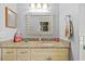 Bathroom featuring a decorative mirror over a granite countertop and an adjacent shower at 7213 Jones Rd, Odessa, FL 33556