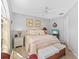 Cozy bedroom featuring a ceiling fan, charming decor, and inviting furnishings at 7213 Jones Rd, Odessa, FL 33556