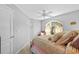 Bedroom boasts vaulted ceilings, ceiling fan, and large window with custom curtains at 7213 Jones Rd, Odessa, FL 33556