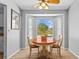 Bright breakfast nook features bay windows, table, chairs, and backyard pool views at 7213 Jones Rd, Odessa, FL 33556