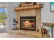 Cozy fireplace with marble facade, glass doors, and decorative mantle at 7213 Jones Rd, Odessa, FL 33556