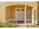 Inviting front entrance featuring double doors, decorative security gate and brick walkway at 7213 Jones Rd, Odessa, FL 33556