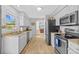Open-concept kitchen features granite countertops, stainless appliances and ample cabinets at 7213 Jones Rd, Odessa, FL 33556