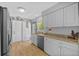 Well-lit kitchen features stainless appliances, granite counters, and ample cabinet space at 7213 Jones Rd, Odessa, FL 33556