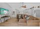 Comfortable living room with a sectional sofa, fireplace, light floors, and a bar sink with convenient accessibility at 7213 Jones Rd, Odessa, FL 33556