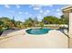 Backyard pool is surrounded by a concrete patio with plenty of space for outdoor lounging and entertaining at 7213 Jones Rd, Odessa, FL 33556