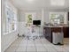 Kitchen area featuring an office desk setup, natural lighting, and tile floors at 821 W Adalee St, Tampa, FL 33603