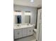 Modern bathroom with double sink vanity, quartz countertop, and updated fixtures at 13224 Foresman Blvd, Port Charlotte, FL 33981