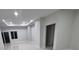 Spacious living room with modern lighting, clean lines, and bright neutral paint at 13224 Foresman Blvd, Port Charlotte, FL 33981