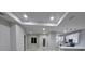 Open-concept living area with modern lighting, leading to the kitchen, and tile floors at 13224 Foresman Blvd, Port Charlotte, FL 33981