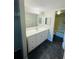 Bright bathroom features a spacious vanity with ample storage and a well-lit mirror at 200 Country Club Dr # 407, Largo, FL 33771