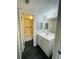Well-lit bathroom features a vanity with ample storage space, a tub, and modern fixtures at 200 Country Club Dr # 407, Largo, FL 33771