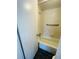 Clean bathtub featuring a safety bar, tile surround, and modern fixtures at 200 Country Club Dr # 407, Largo, FL 33771