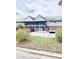 Two-story condo with a blue exterior, brick accents, stairs leading to the second floor and an American flag waving in the wind at 200 Country Club Dr # 407, Largo, FL 33771