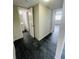 Hallway featuring dark brick flooring that connects the main living spaces, providing easy access to the bathroom and bedroom at 200 Country Club Dr # 407, Largo, FL 33771