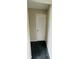 Hallway with tile floors and a door leading to utilities at 200 Country Club Dr # 407, Largo, FL 33771