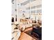 Open-concept living room with wood floors, vaulted ceilings, comfortable seating, and a view of the kitchen area at 200 Country Club Dr # 407, Largo, FL 33771