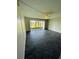 View of the living room showcasing dark brick flooring and sliding glass doors that provide natural light and scenic views at 200 Country Club Dr # 407, Largo, FL 33771