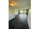 Bright and airy living room featuring dark brick flooring and sliding glass doors that lead to outdoor scenery at 200 Country Club Dr # 407, Largo, FL 33771