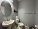 Cozy powder room with a pedestal sink, toilet, and decorative 'PEACE' wall art at 20314 Starfinder Way, Tampa, FL 33647