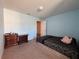 Bedroom with neutral carpet, bright walls, and a view into an adjoining hall at 20314 Starfinder Way, Tampa, FL 33647