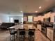 Updated kitchen with white cabinets, granite countertops, stainless appliances, and breakfast bar seating at 20314 Starfinder Way, Tampa, FL 33647