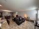 Open-concept living room with tile flooring, offering a seamless transition to the dining and kitchen areas at 20314 Starfinder Way, Tampa, FL 33647