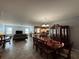 Spacious living room with neutral tile floors, dining area, and seamless flow into the kitchen area at 20314 Starfinder Way, Tampa, FL 33647