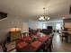 Bright and spacious living room with tiled floors, chandelier, and dining area perfect for gatherings at 20314 Starfinder Way, Tampa, FL 33647