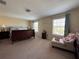 Serene main bedroom with a large window, plush carpet, and neutral color palette at 20314 Starfinder Way, Tampa, FL 33647