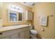 Bathroom featuring a granite vanity top, decorative mirror, and modern toilet at 325 Grayston Pl # 114, Sun City Center, FL 33573