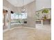 Bright dining area features tile floors, a modern light fixture, and views of the pool and lanai at 3830 Moreno Dr, Palm Harbor, FL 34685