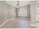 A bright dining room with tile flooring, chandelier, and a large window for natural light at 3830 Moreno Dr, Palm Harbor, FL 34685