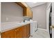 Functional laundry room with sink, ample cabinet space, and modern washer and dryer units at 3830 Moreno Dr, Palm Harbor, FL 34685