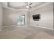 Expansive primary suite featuring a ceiling fan and sliding glass doors leading to the pool area at 3830 Moreno Dr, Palm Harbor, FL 34685