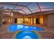 Stunning pool and spa area with brick patio and screened enclosure for year-round enjoyment at 3830 Moreno Dr, Palm Harbor, FL 34685