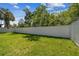 Large, lush backyard enclosed by a pristine white fence, providing privacy and space for outdoor activities at 4406 W Euclid Ave, Tampa, FL 33629