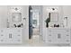 Bright bathroom featuring dual sink vanities, elegant fixtures, and access to the main bedroom at 4406 W Euclid Ave, Tampa, FL 33629