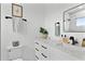 Bathroom featuring a sleek toilet, modern fixtures, and a black framed mirror at 4406 W Euclid Ave, Tampa, FL 33629
