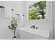 Elegant bathroom featuring a freestanding tub with stylish fixtures and natural light at 4406 W Euclid Ave, Tampa, FL 33629