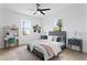 Bright bedroom with a ceiling fan, natural light, and a cozy rug at 4406 W Euclid Ave, Tampa, FL 33629