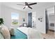 Bright bedroom featuring natural light, en suite bathroom, and an accent chair at 4406 W Euclid Ave, Tampa, FL 33629