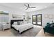 Bedroom featuring a plush bed, stylish ceiling fan, and direct access to an outdoor space at 4406 W Euclid Ave, Tampa, FL 33629