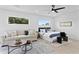 Bright bedroom featuring modern furniture, a ceiling fan, and natural light from two large windows at 4406 W Euclid Ave, Tampa, FL 33629
