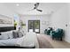 Bright bedroom featuring a ceiling fan and French doors that open to the outside at 4406 W Euclid Ave, Tampa, FL 33629