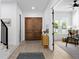 Welcoming entryway featuring hardwood floors, wooden doors, and seamless access to the cozy living area at 4406 W Euclid Ave, Tampa, FL 33629