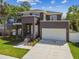 Beautiful exterior of a modern two-story home with a large garage and well-kept lawn and landscaping at 4406 W Euclid Ave, Tampa, FL 33629