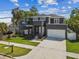 Stylish home with a modern facade, balcony, two-car garage and a green lawn with tidy landscaping at 4406 W Euclid Ave, Tampa, FL 33629