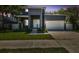 Elegant two-story home with modern design, a two-car garage, and manicured lawn at 4406 W Euclid Ave, Tampa, FL 33629